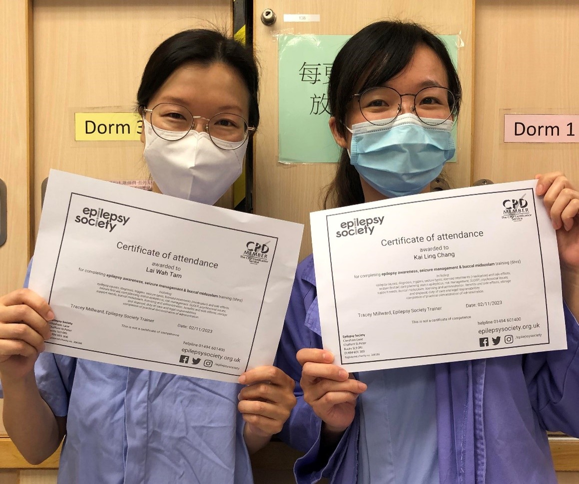 Two nurses with their certificates