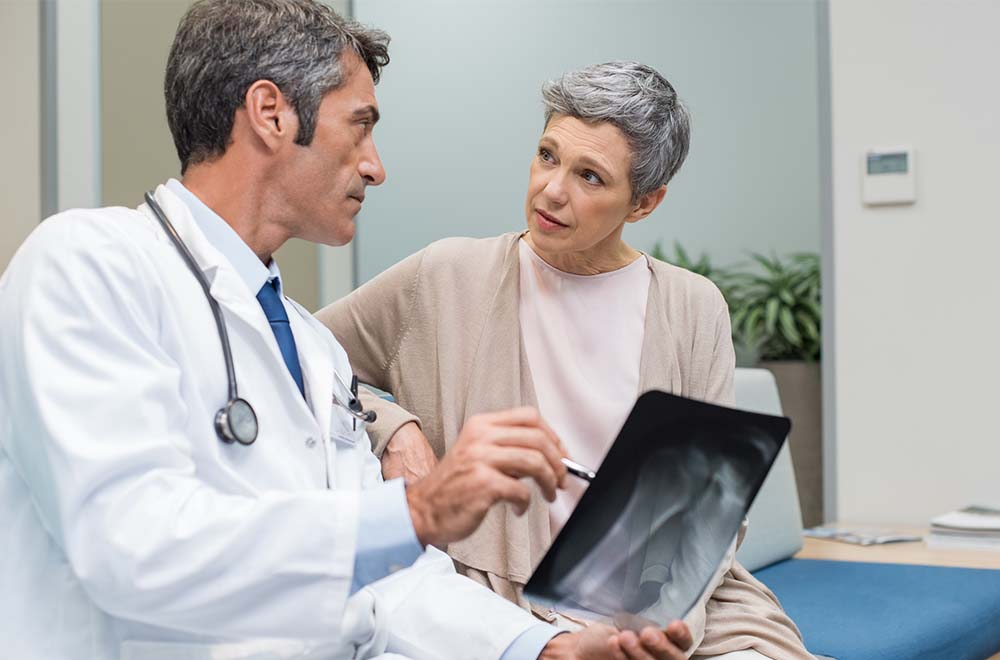woman with osteoporosis and doctor