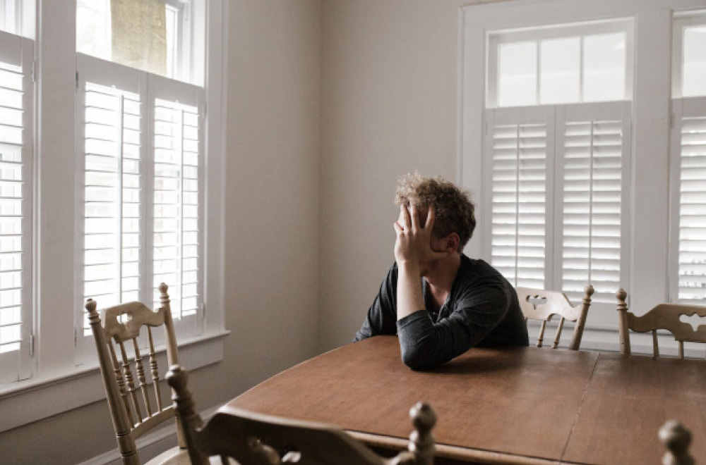 man looking out of window