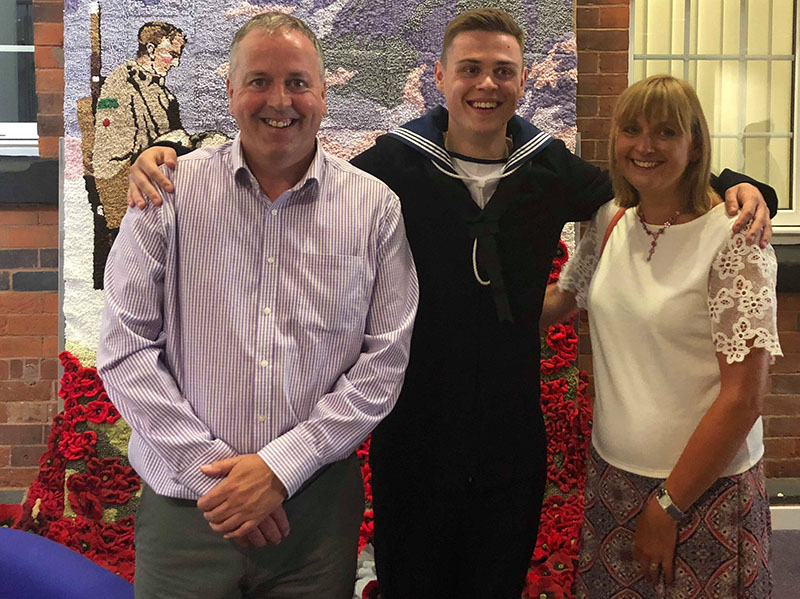Dan in naval uniform with his parents.