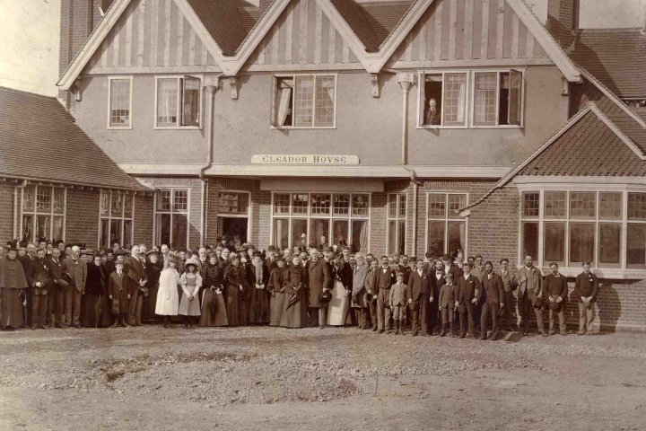 old sepia photo of Eleanor House with staff and patients grouped outside