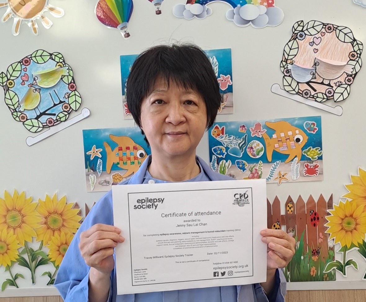 A nurse with her certificate