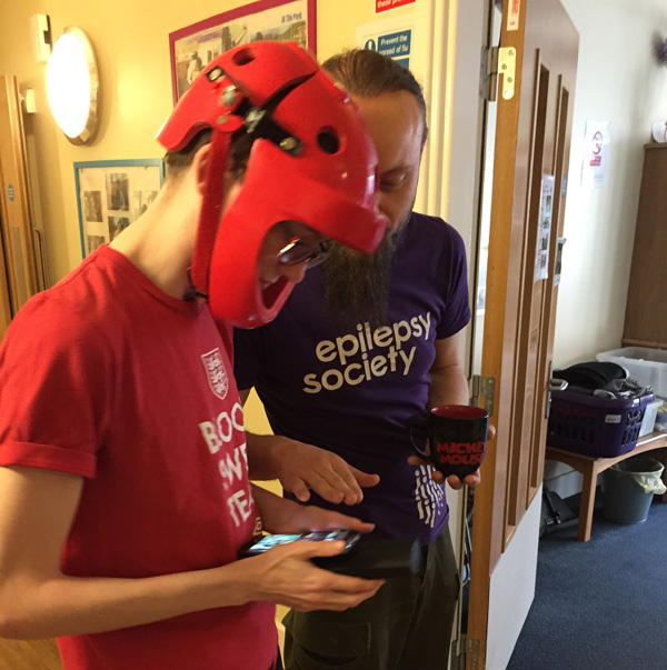 Two people looking at a mobile phone.