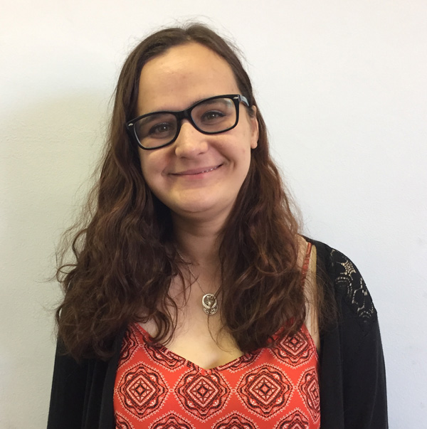 Smiling woman with dark hair and glasses