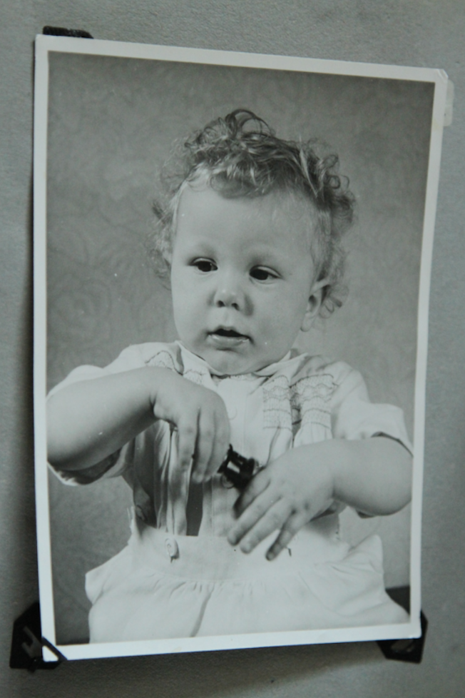 A black and white photograph of David as a baby
