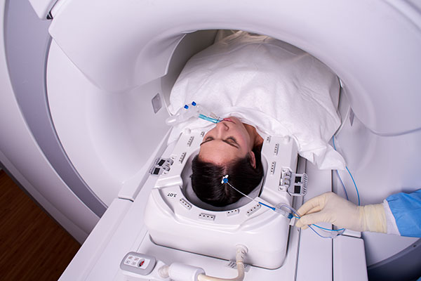 Laser beam therapy is carried out on patient while they are in an MRI scanner.