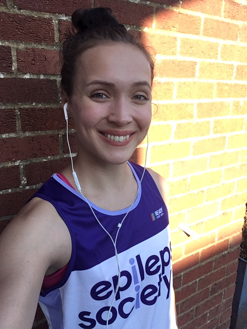 smiling woman in a running vest.