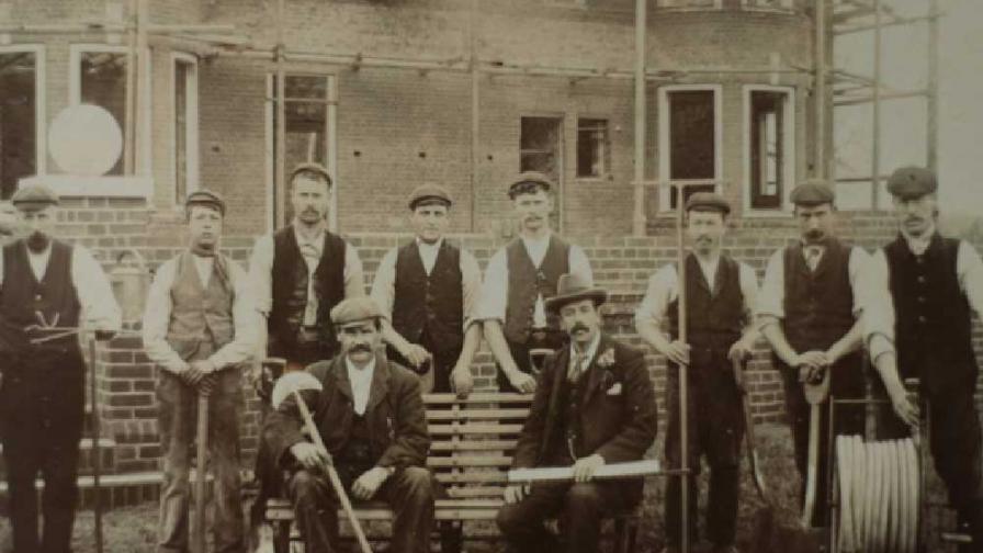 A group of men posing with tools