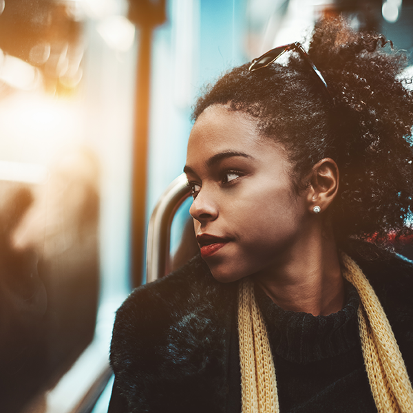 A woman looking out of a bus window