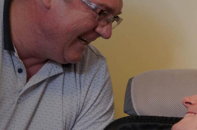 A man looking after one of our residents in our care homes